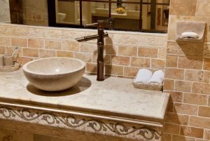 Elegant bathroom sink with tan tile