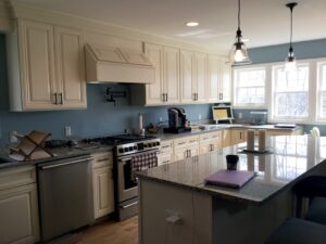 Newly renovated kitchen with white cabinets and a large island